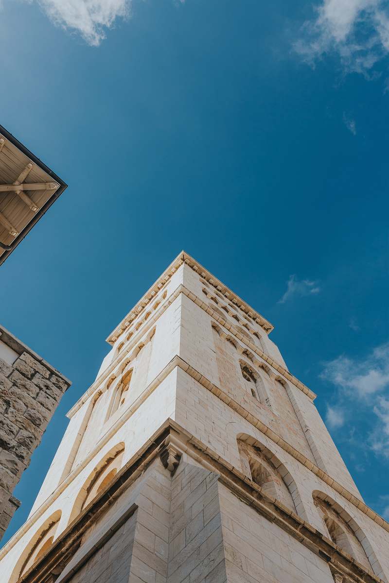 building white concrete building during daytime low-angle photography tower