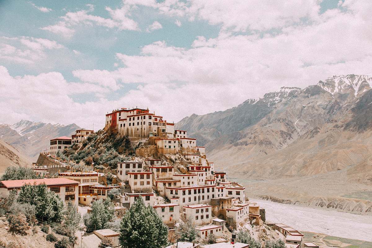 building white concrete houses near mountain monastery