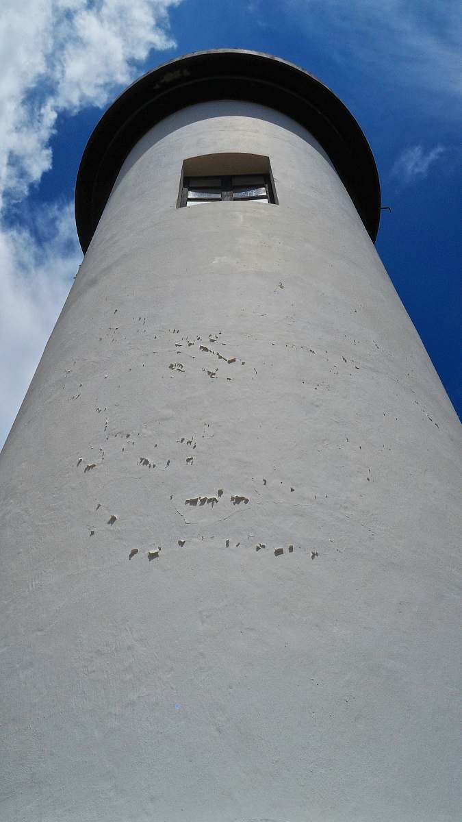 building white lighthouse under blue sky lighthouse