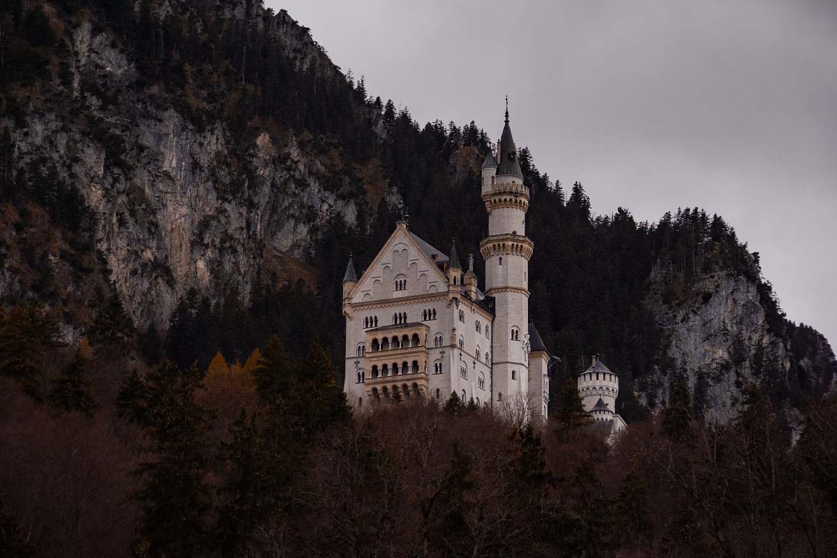 building white painted castle in mountain top castle