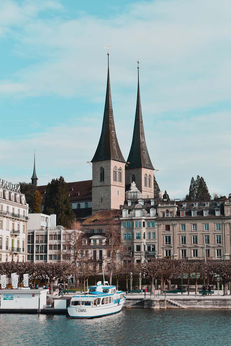 building white yacht beside dock steeple