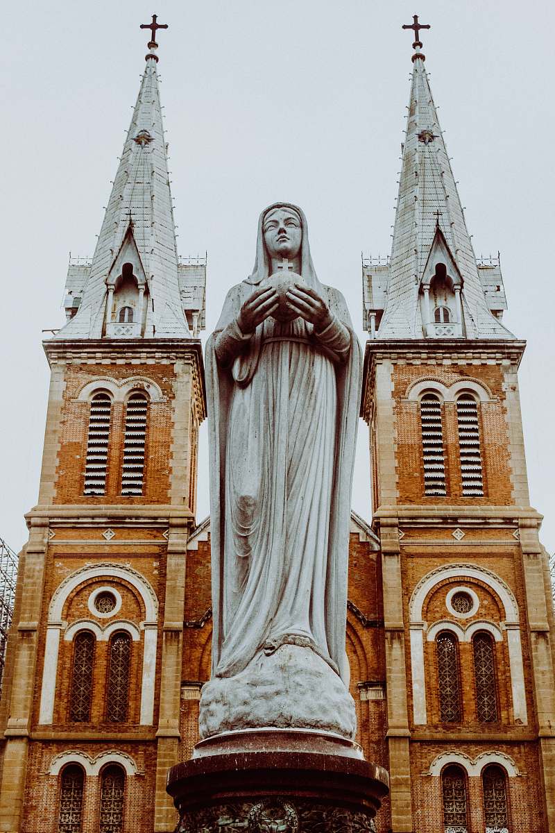 building woman religious statue tower