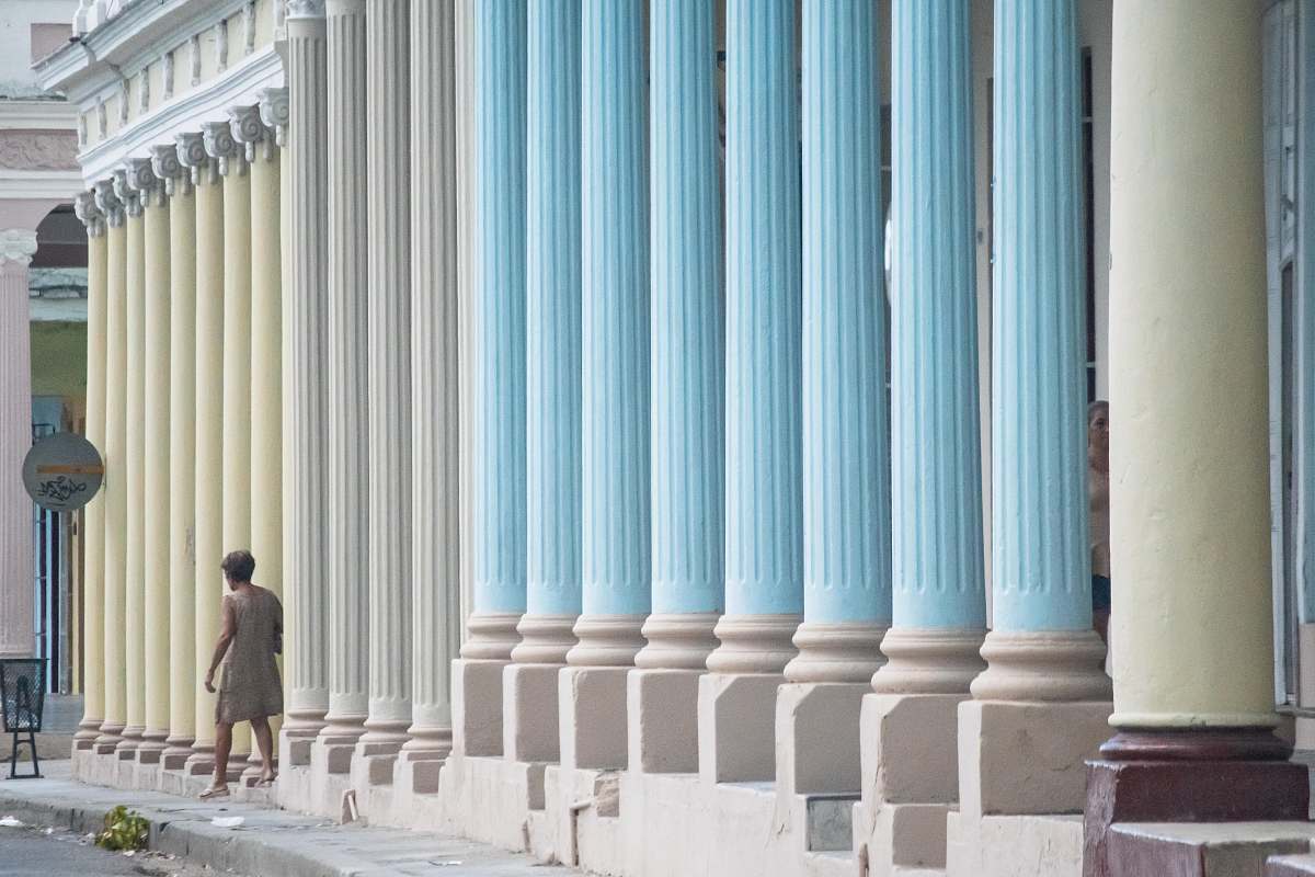building woman standing near building column posts human