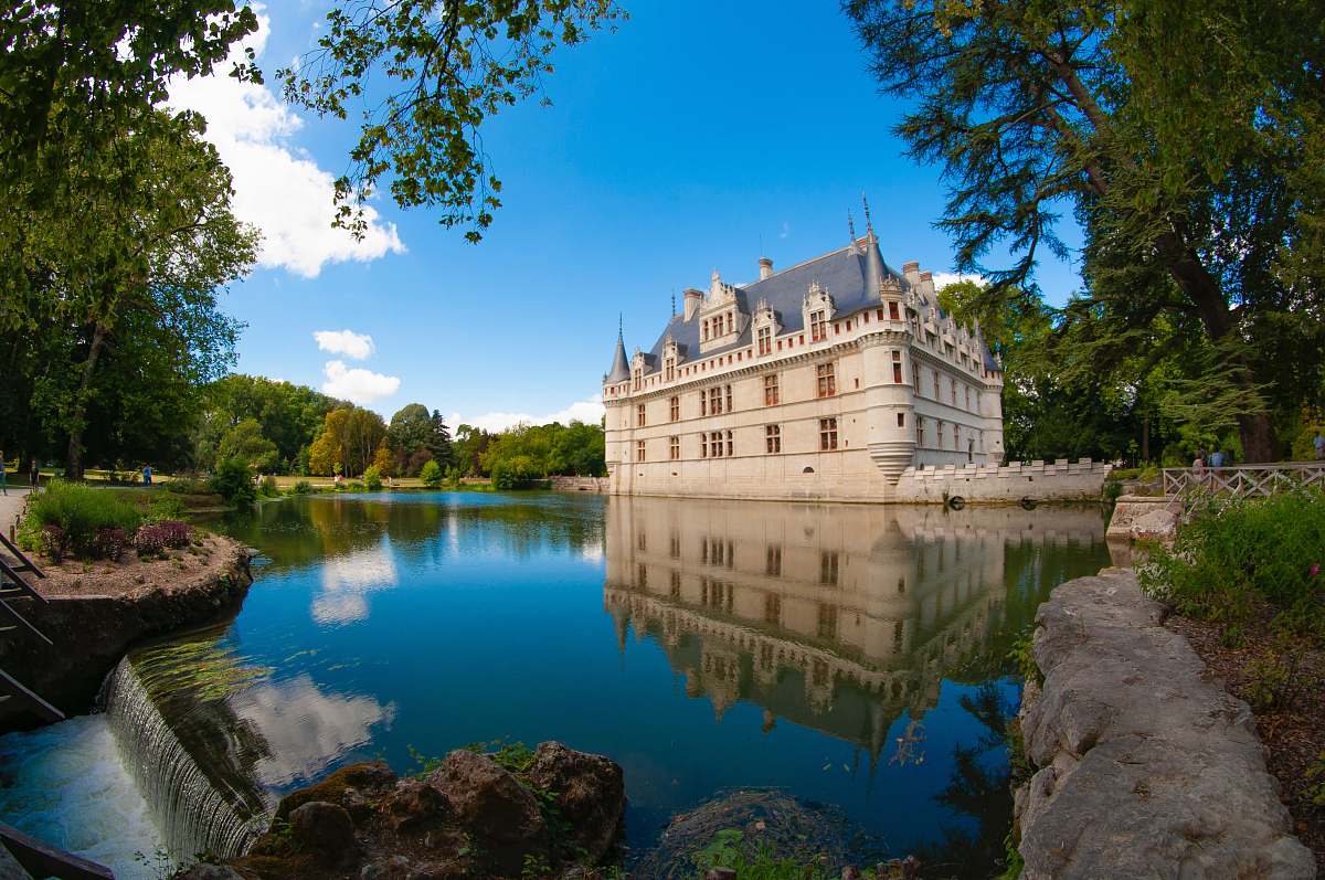 architecture blue roofed white castle surround with water during daytime castle