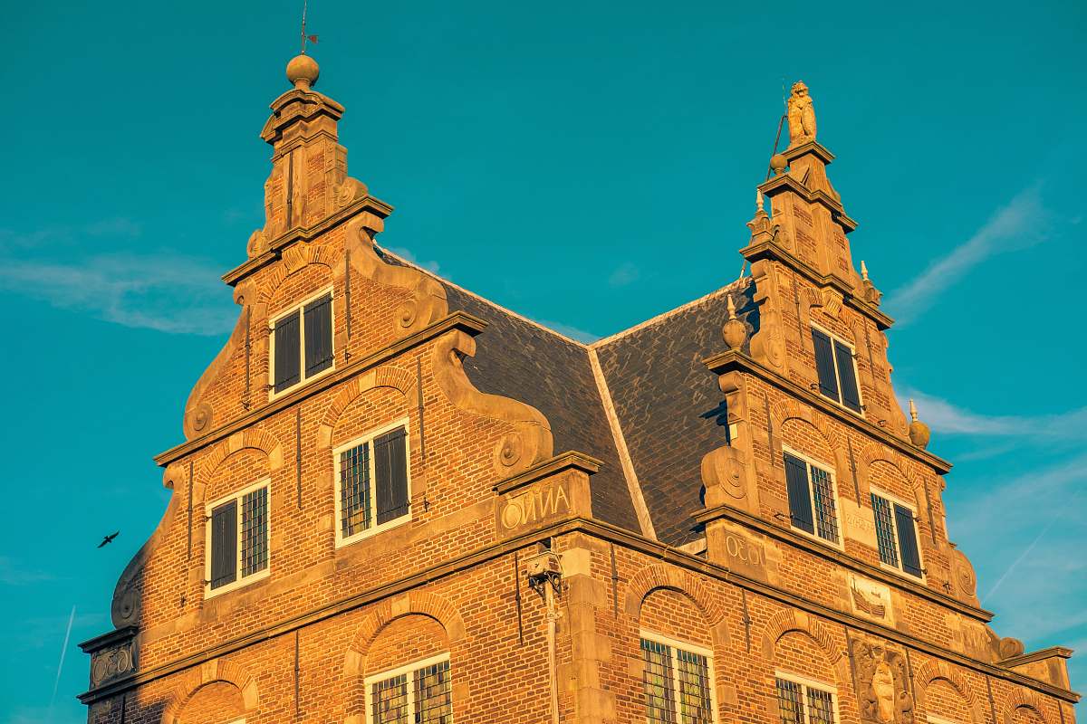 architecture brown brick building under blue sky spire