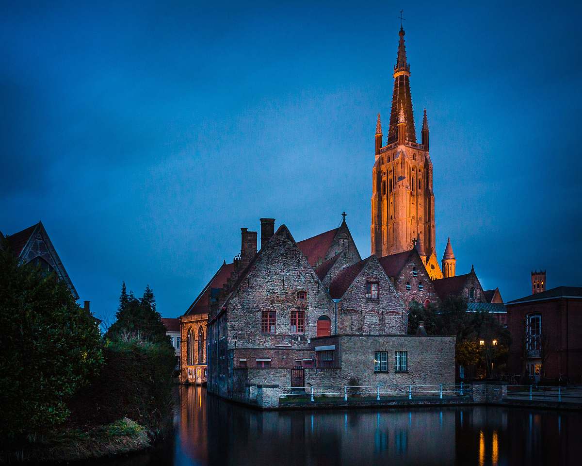 tower brown brick house across yellow tower spire