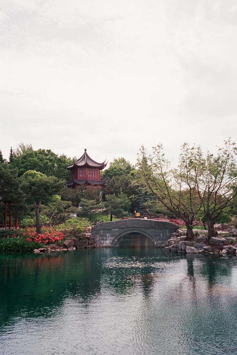 architecture brown temple near bridge and body of water during daytime castle