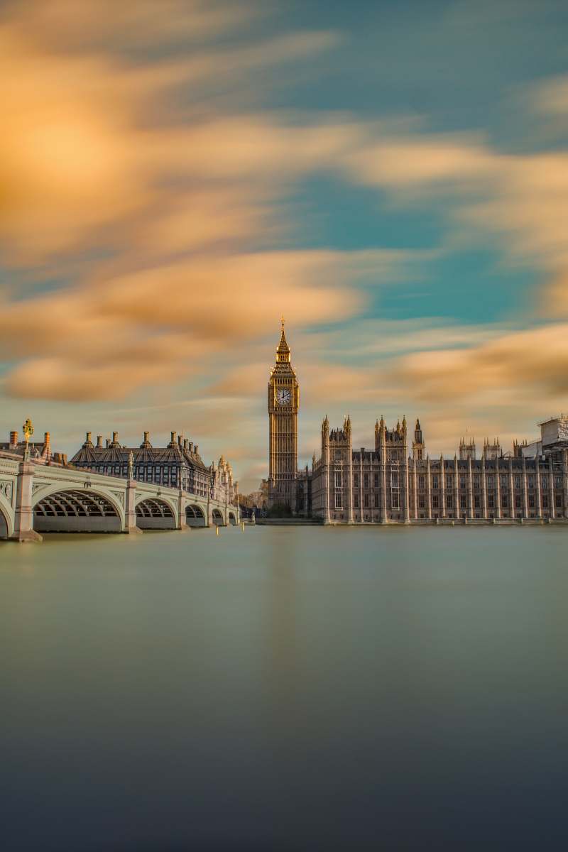 architecture brown tower clock under cloudy sy tower