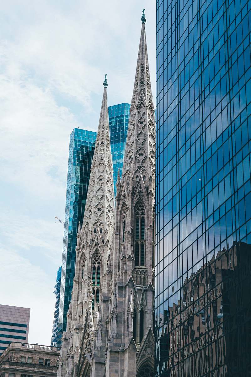 spire cathedral beside buildings tower