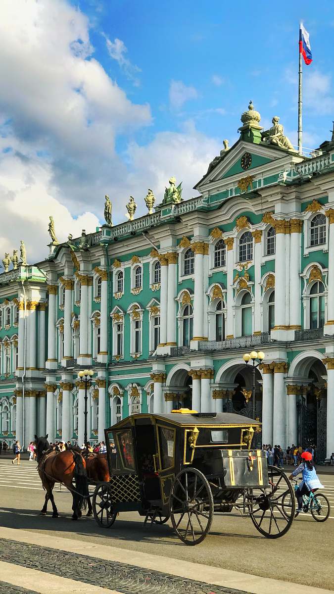architecture horse with carriage running beside building palace