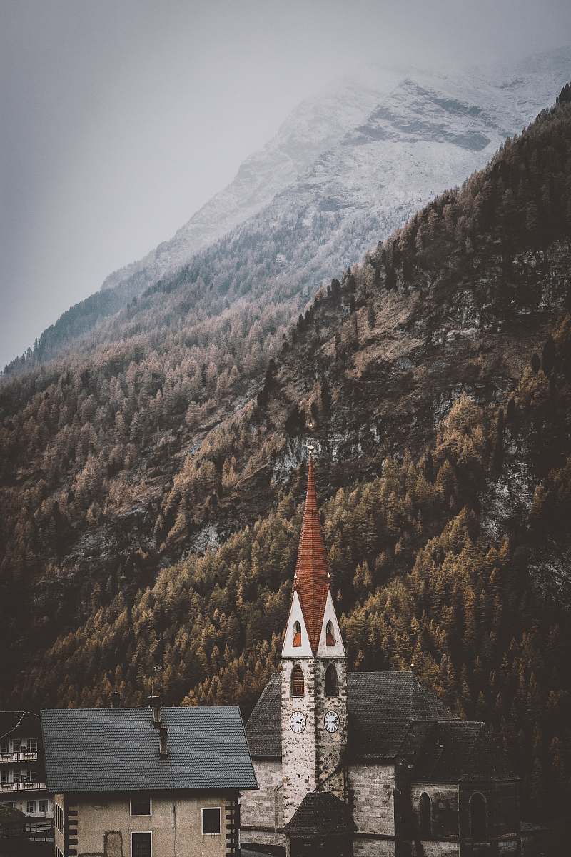 tower houses near mountain steeple