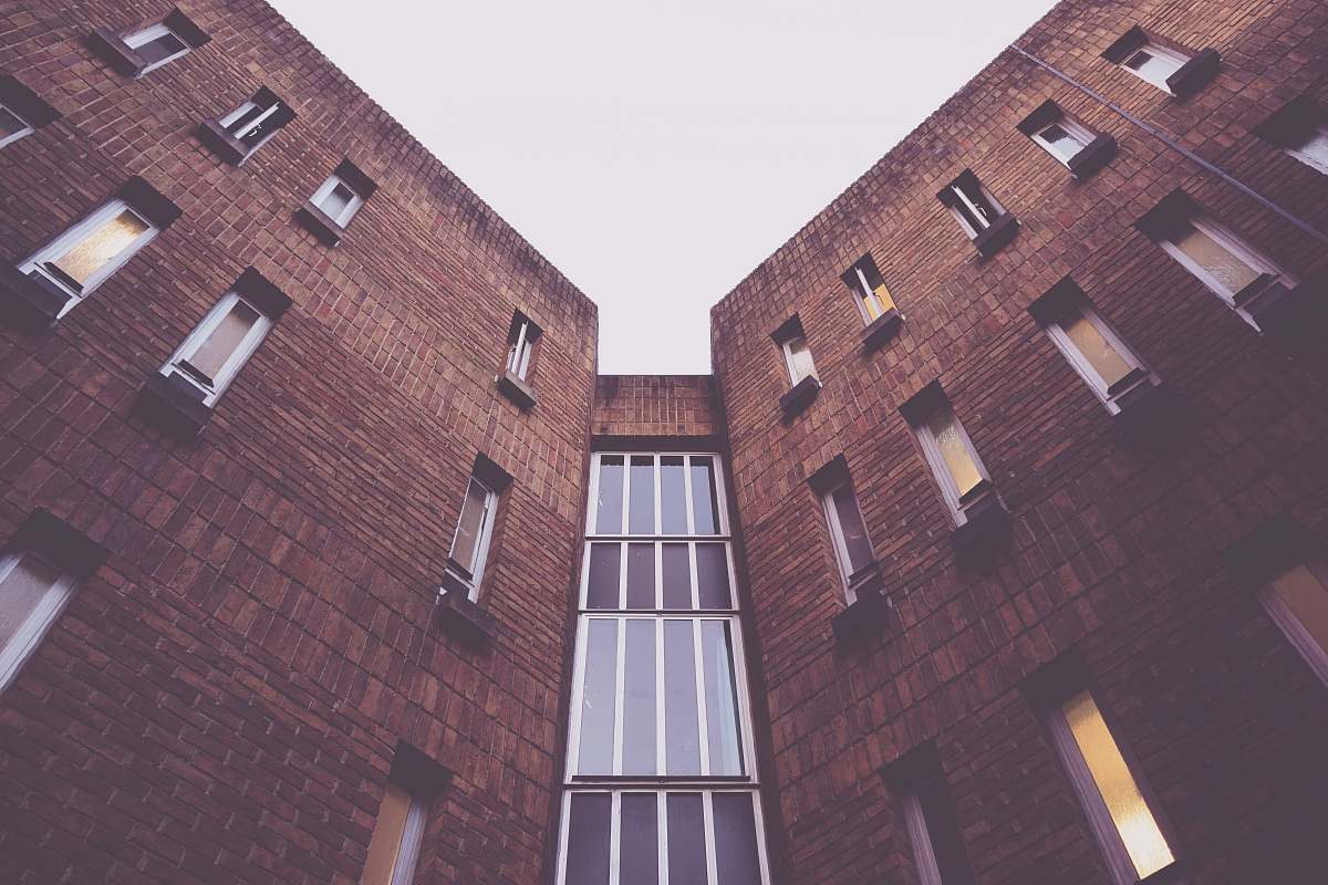architecture low-angle photography of brown concrete building window