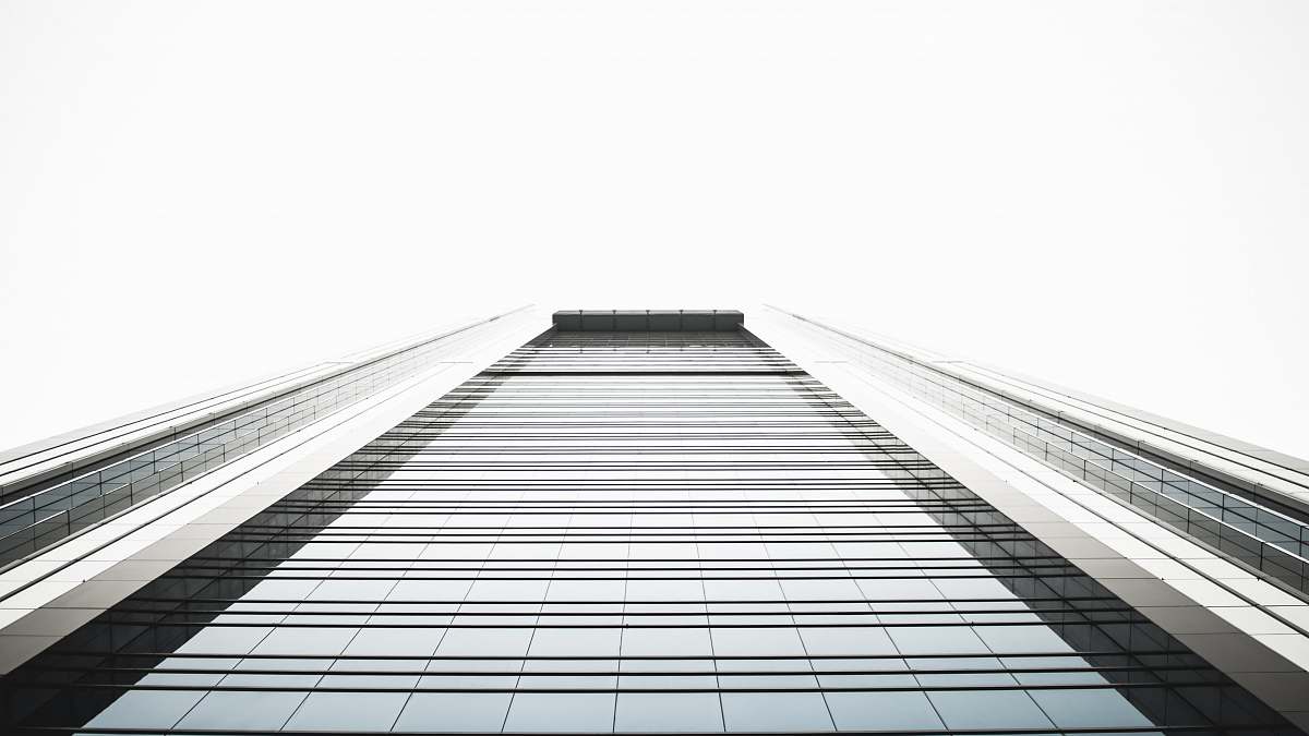 architecture low angle photography of highrise building black-and-white