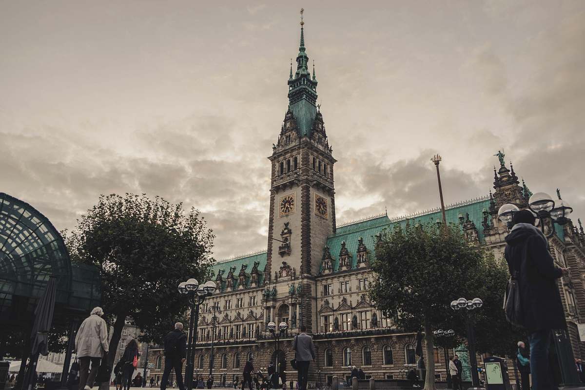 architecture people walking near Hamburg City Hall in Germany under gray skies during daytime tower