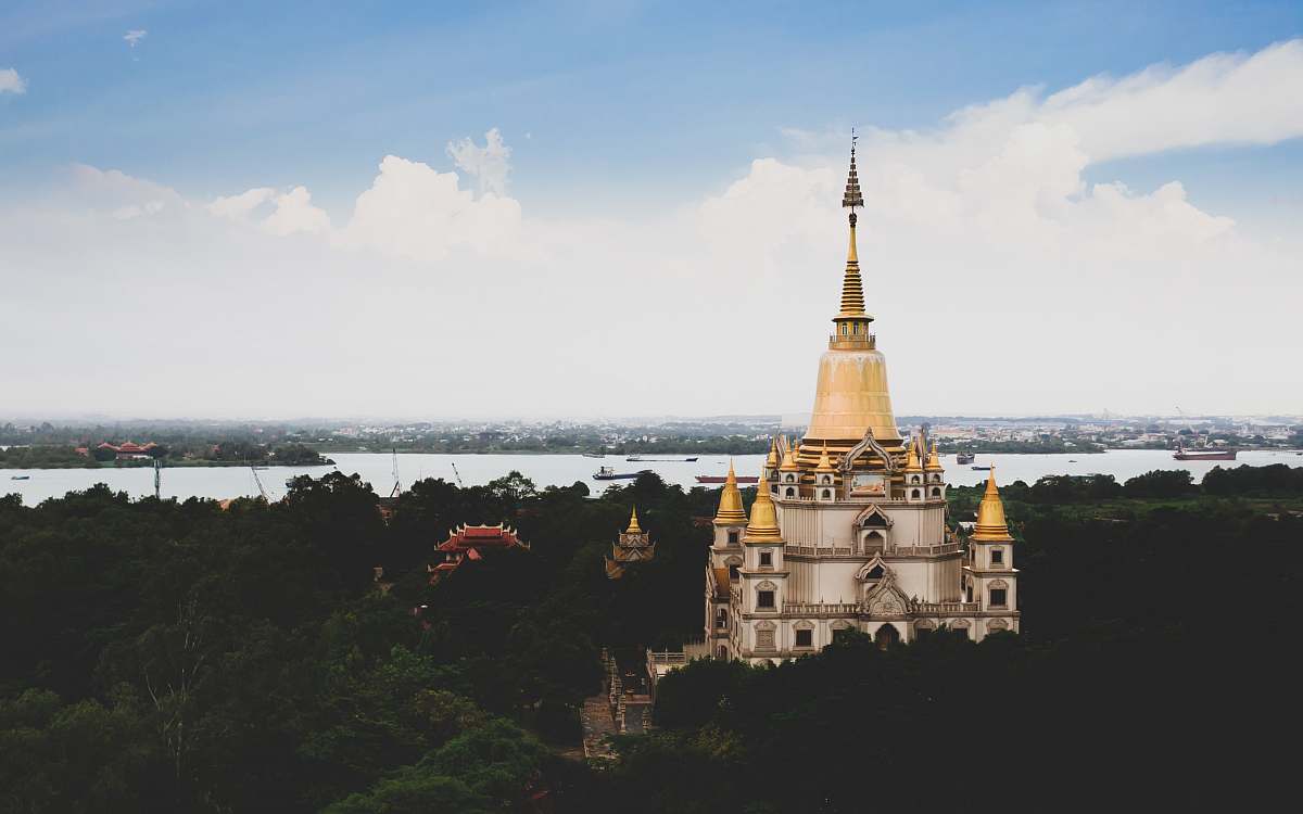 architecture white and yellow mosque across body of water spire