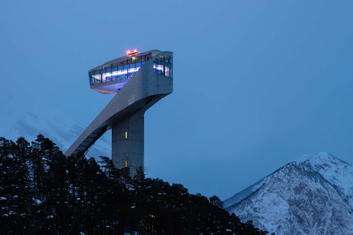 architecture white tower near snow-capped mountain tower