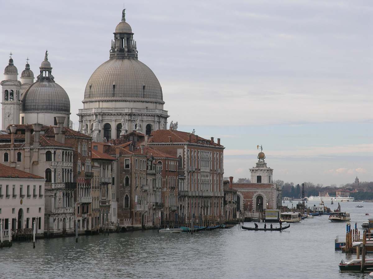 building grey concrete dome building near body of water architecture