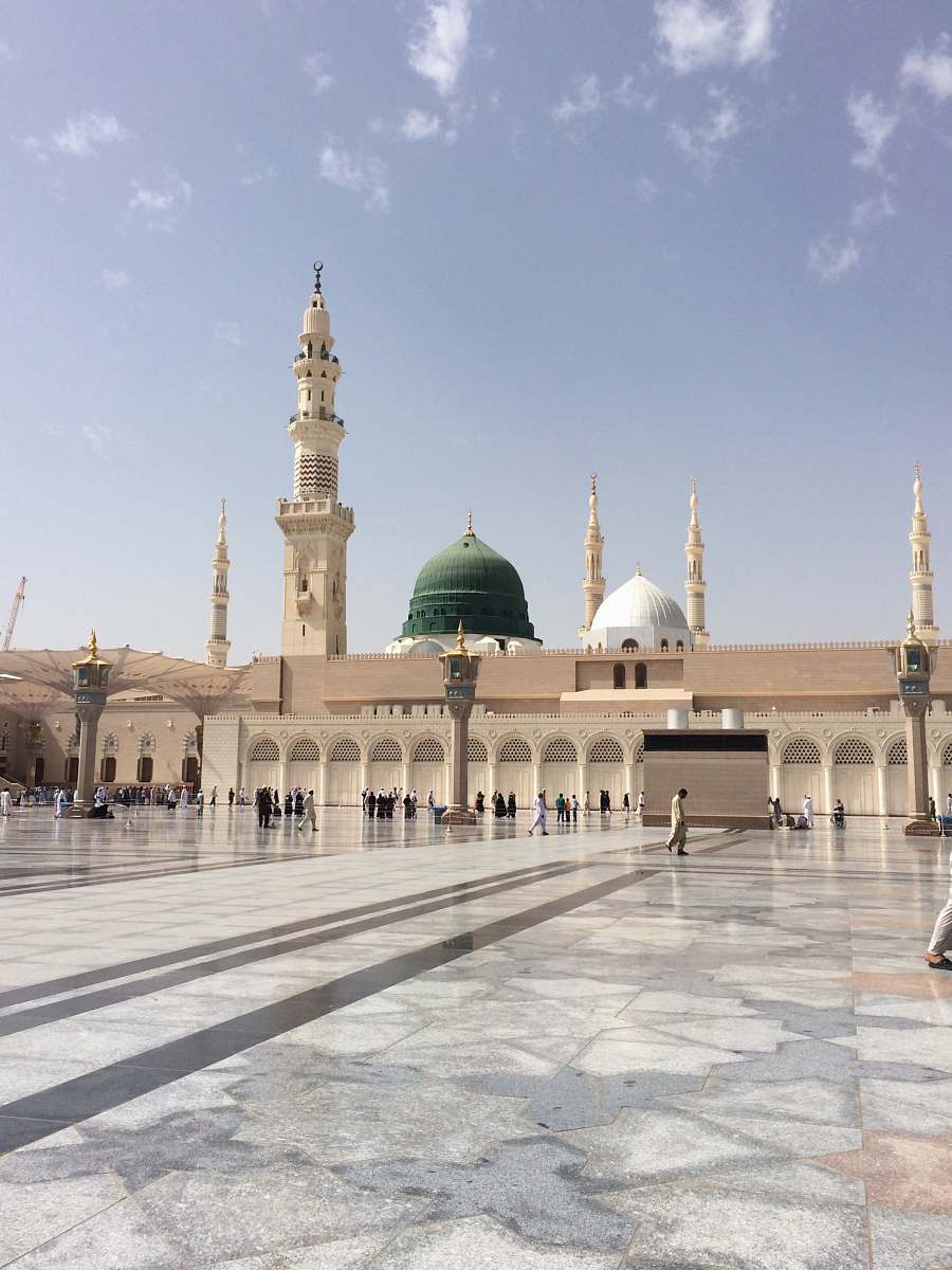 architecture people walking outside a dome mosque building building