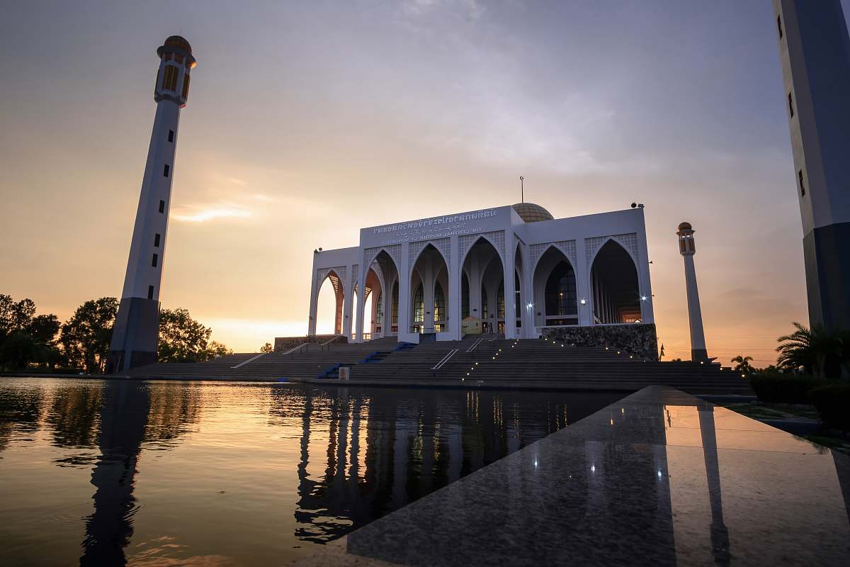 building white mosque with pond in front architecture