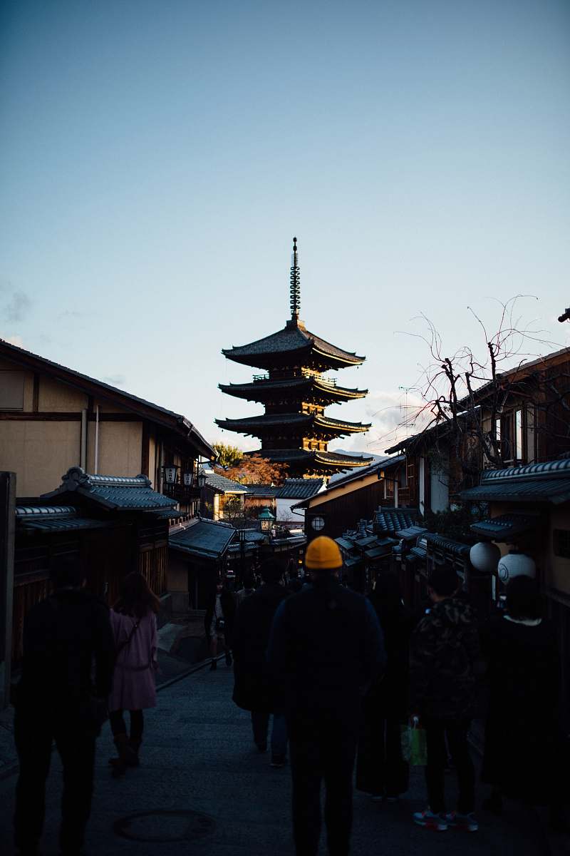 temple people walking on street near houses during daytime worship