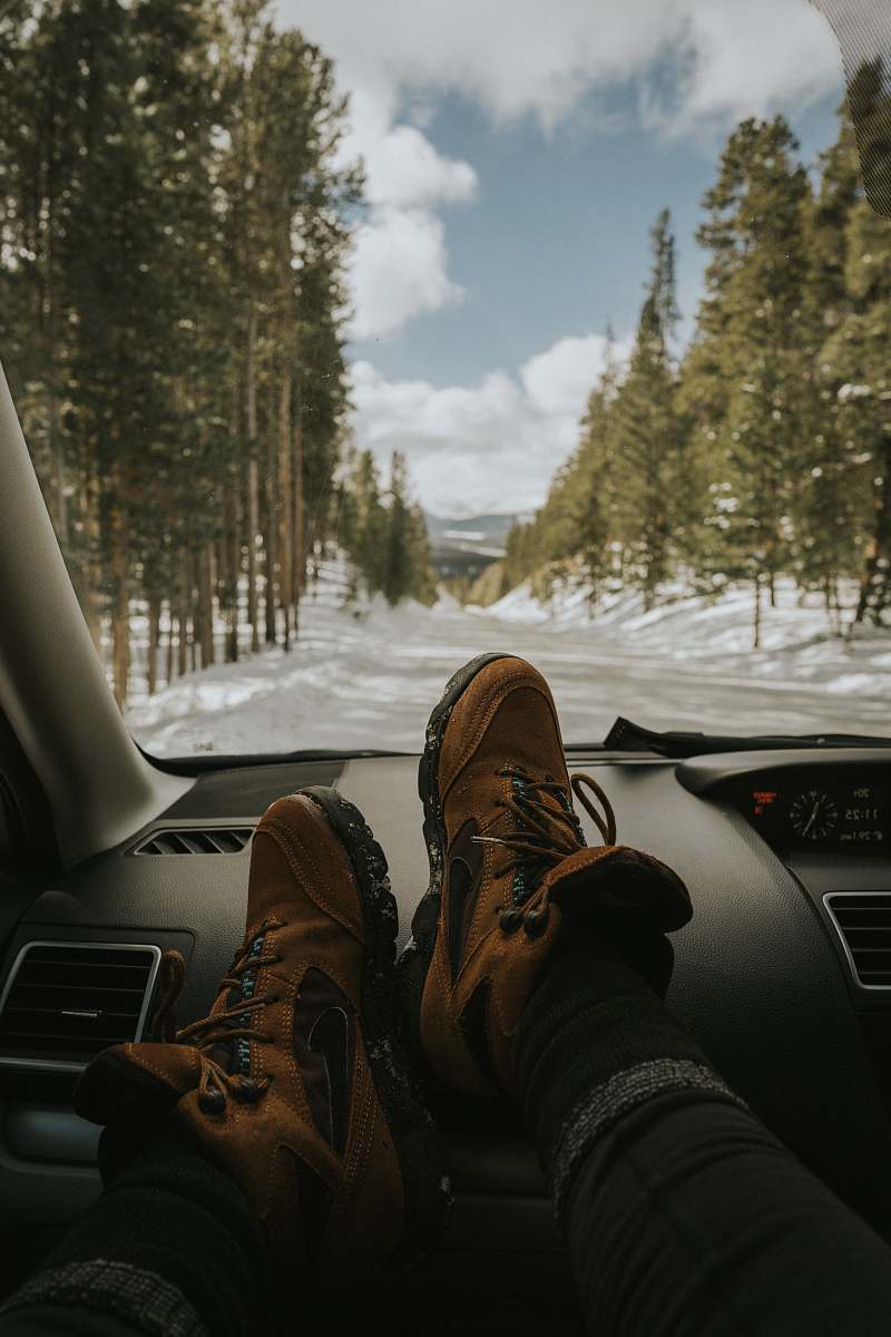 clothing man resting his feet on vehicle dashboard footwear