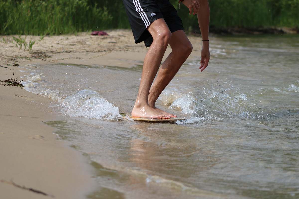clothing person in black shorts running on water during daytime shorts