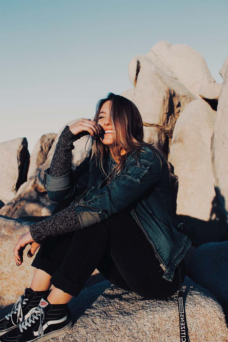 clothing sitting and smiling woman wearing black pants joshua tree