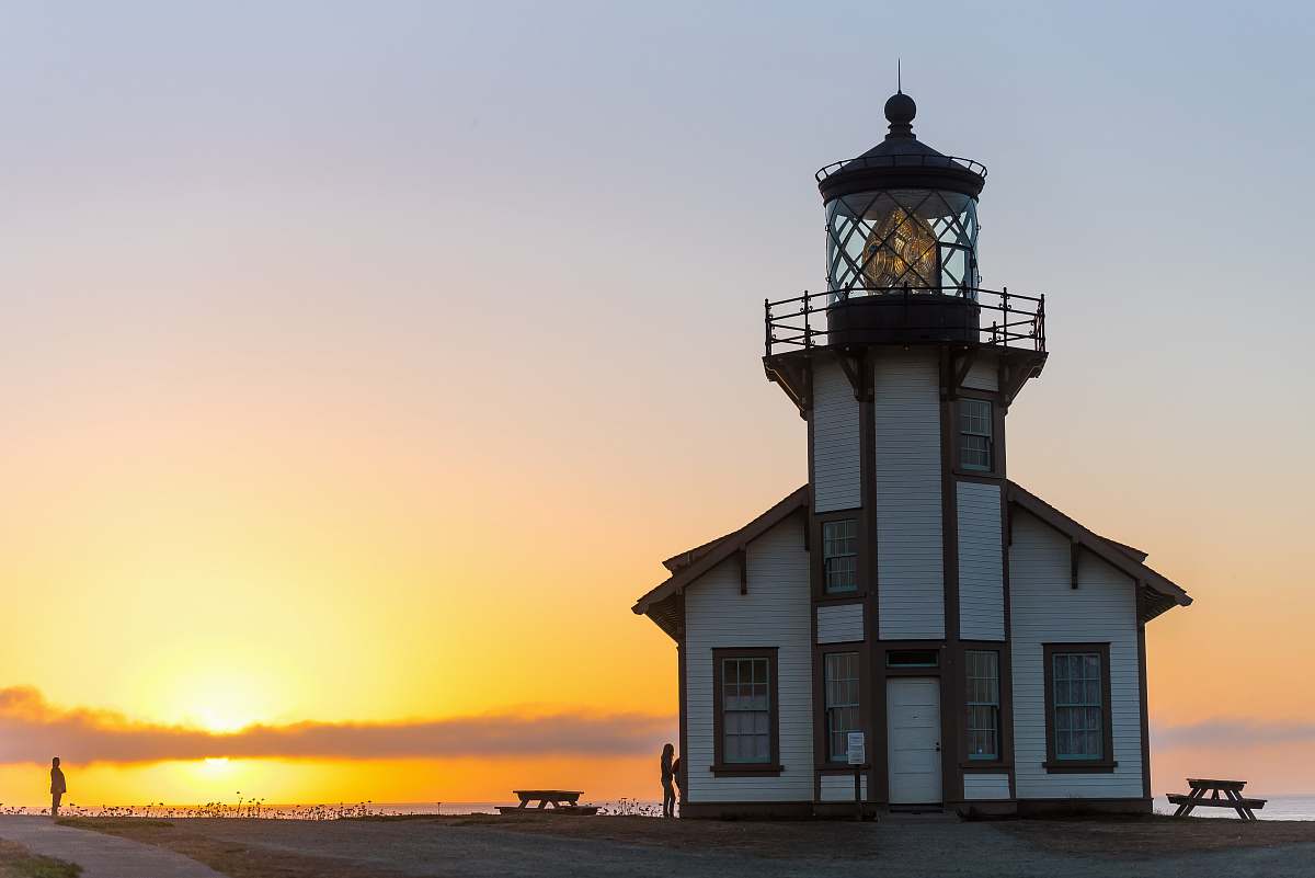 building white and brown lighthouse tower view during sunset tower
