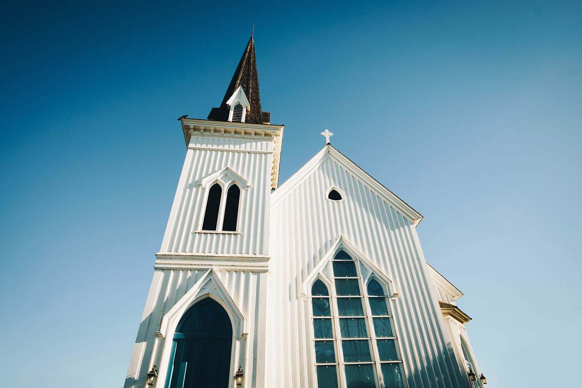 building worm's-eye view photography of white and brown church spire