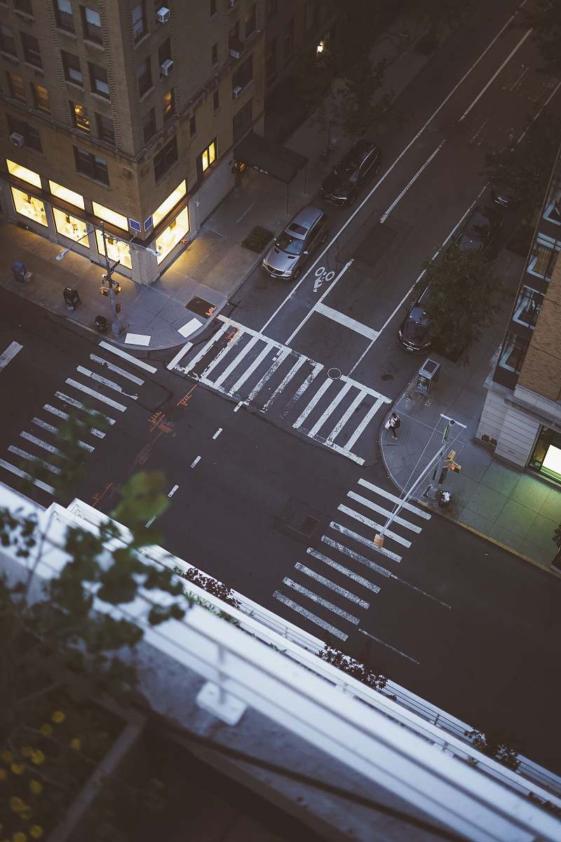 road aerial view of car parked beside building tarmac