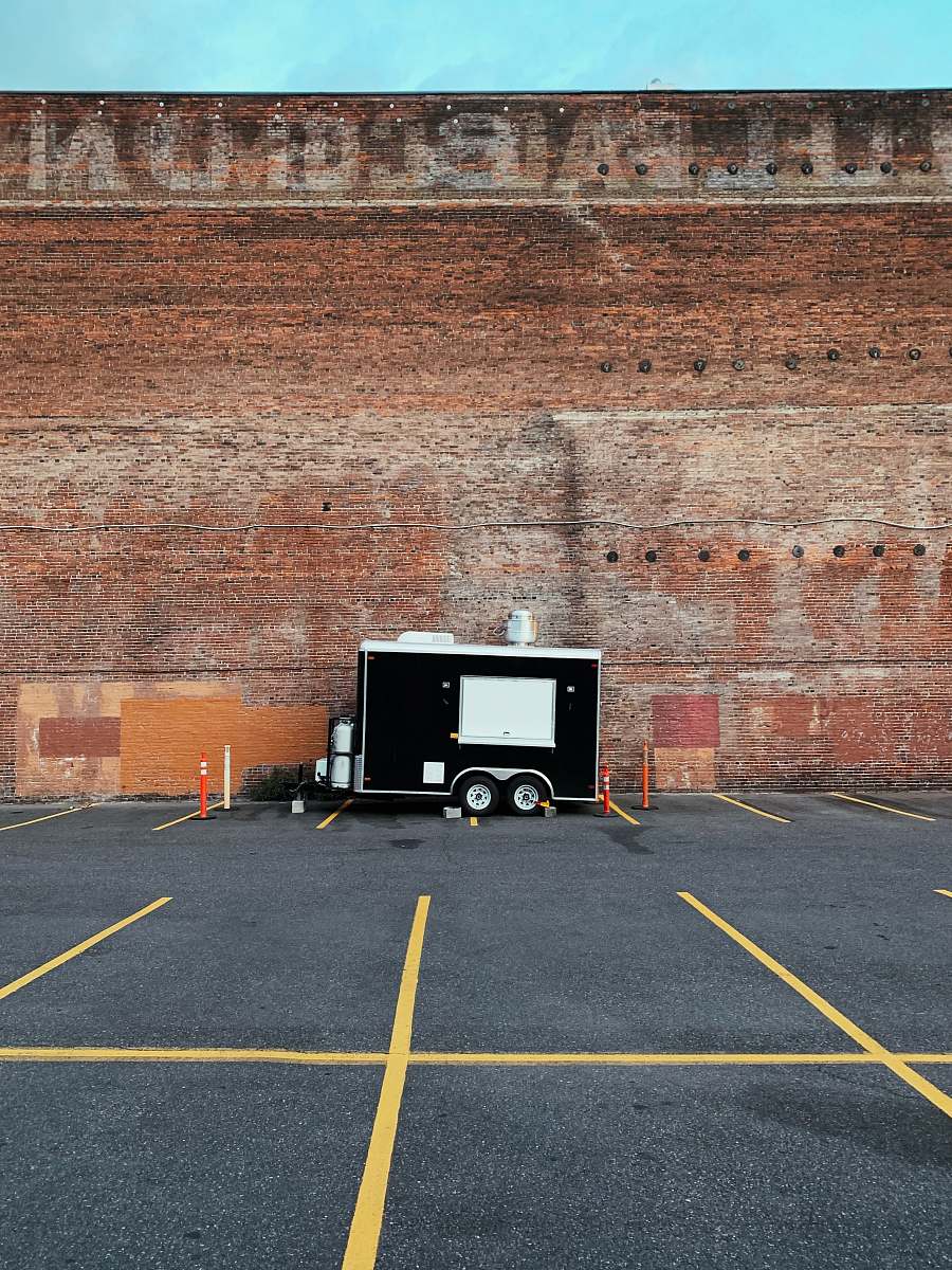 tarmac black and white enclosed trailer near wall portland