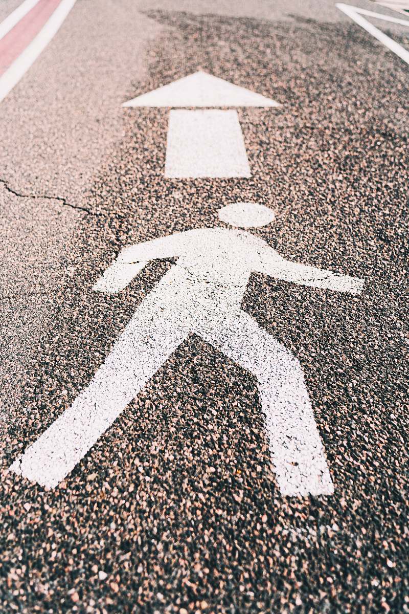 tarmac white arrow sign on gray asphalt road road