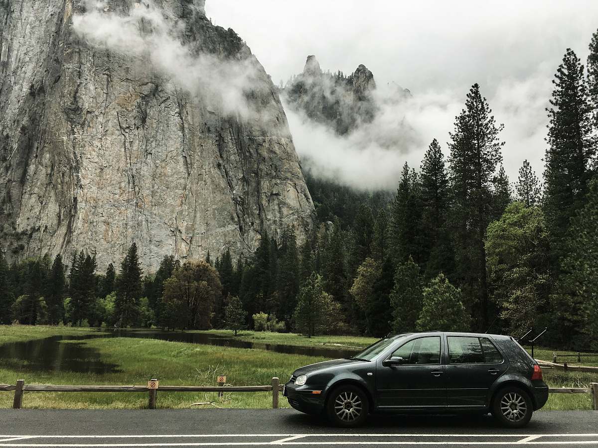 transportation gray 5-door hatchback on the road near trees and mountain car