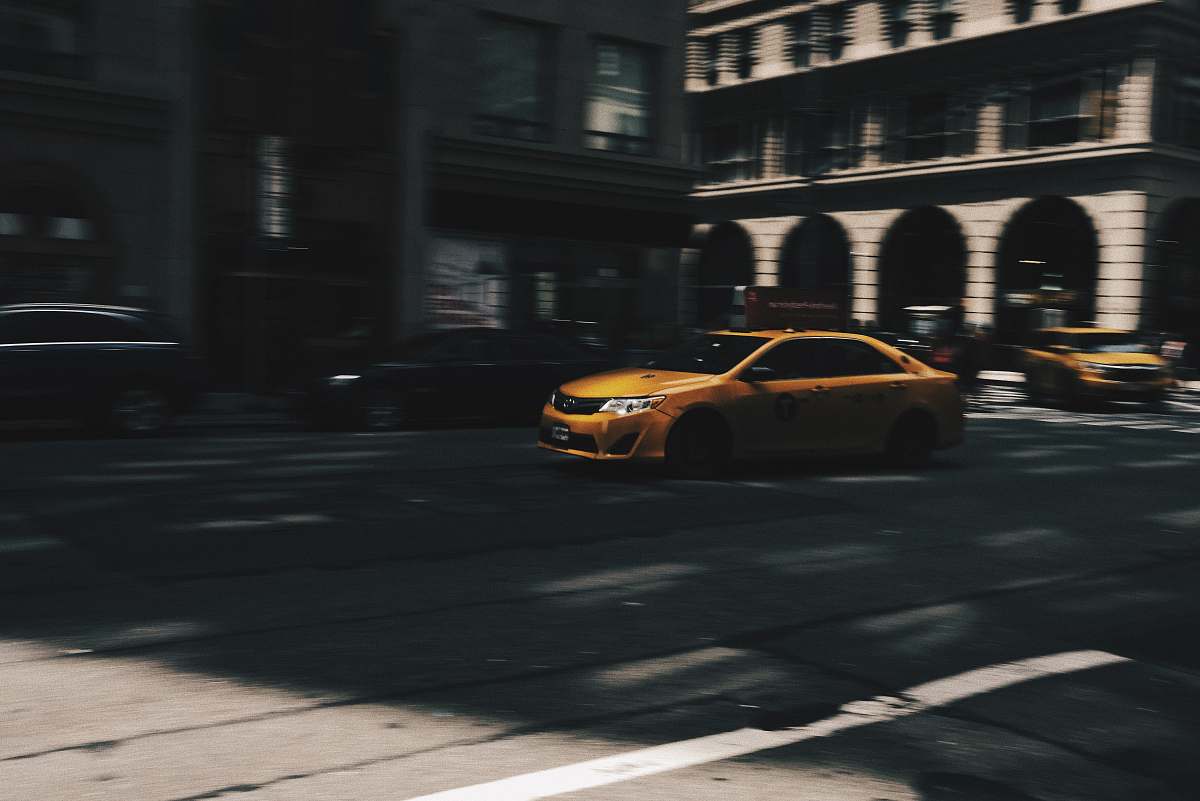 cab selective focus photo of beige metallic sedan car