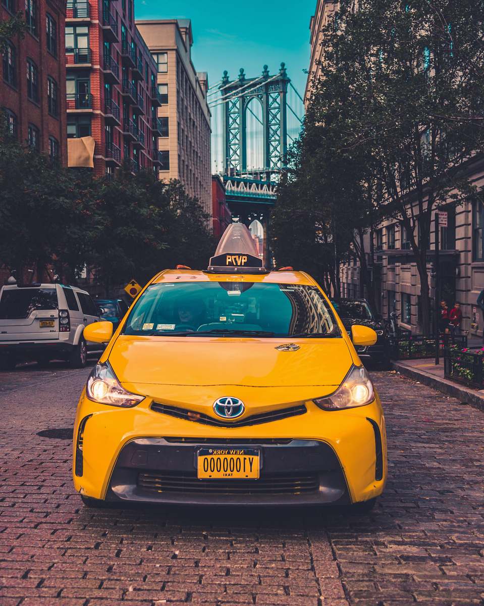cab yellow Toyota taxi cab parked near building car