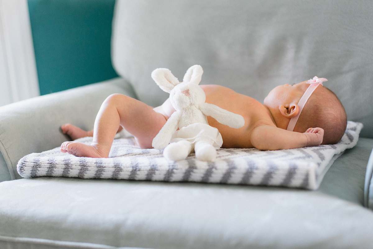 newborn baby on white and gray mat child