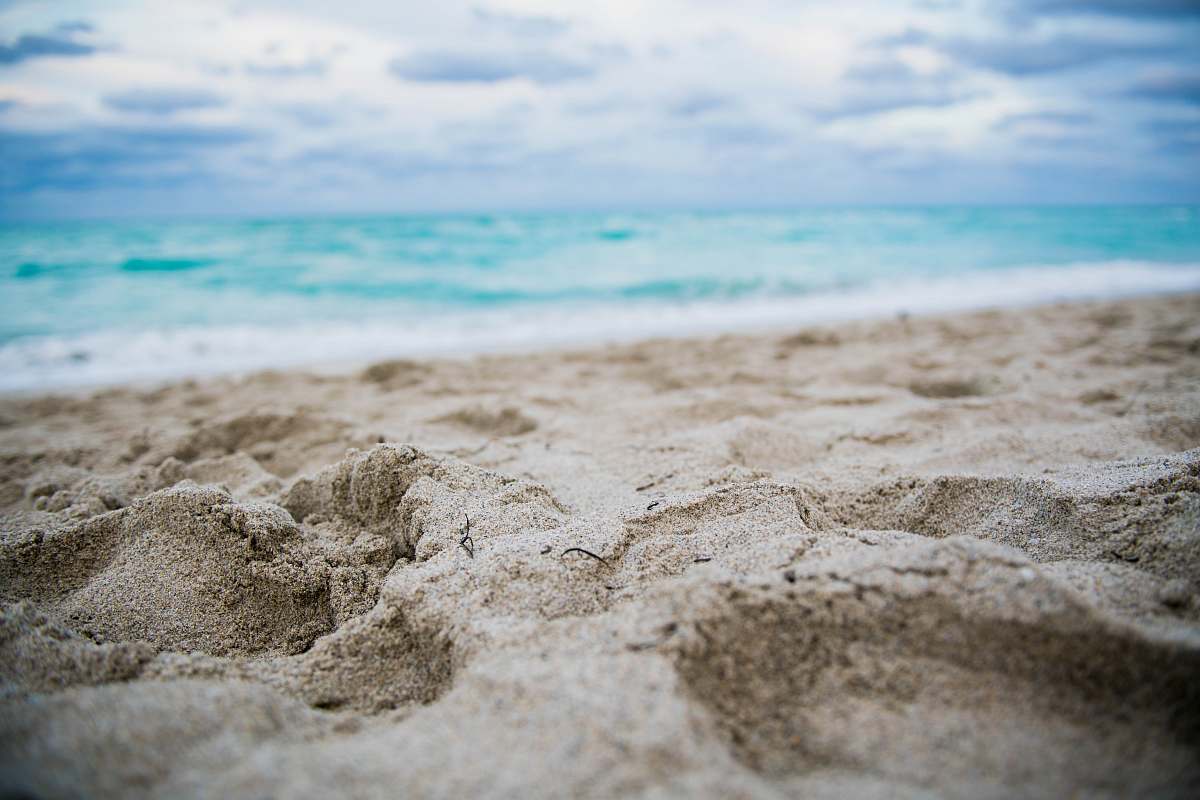 ocean close up photography of footprints on shore sea