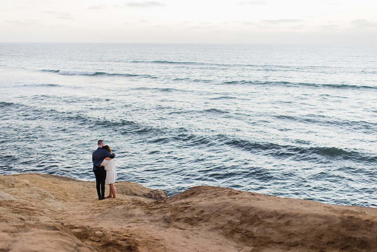 ocean man and woman facing body of water couple