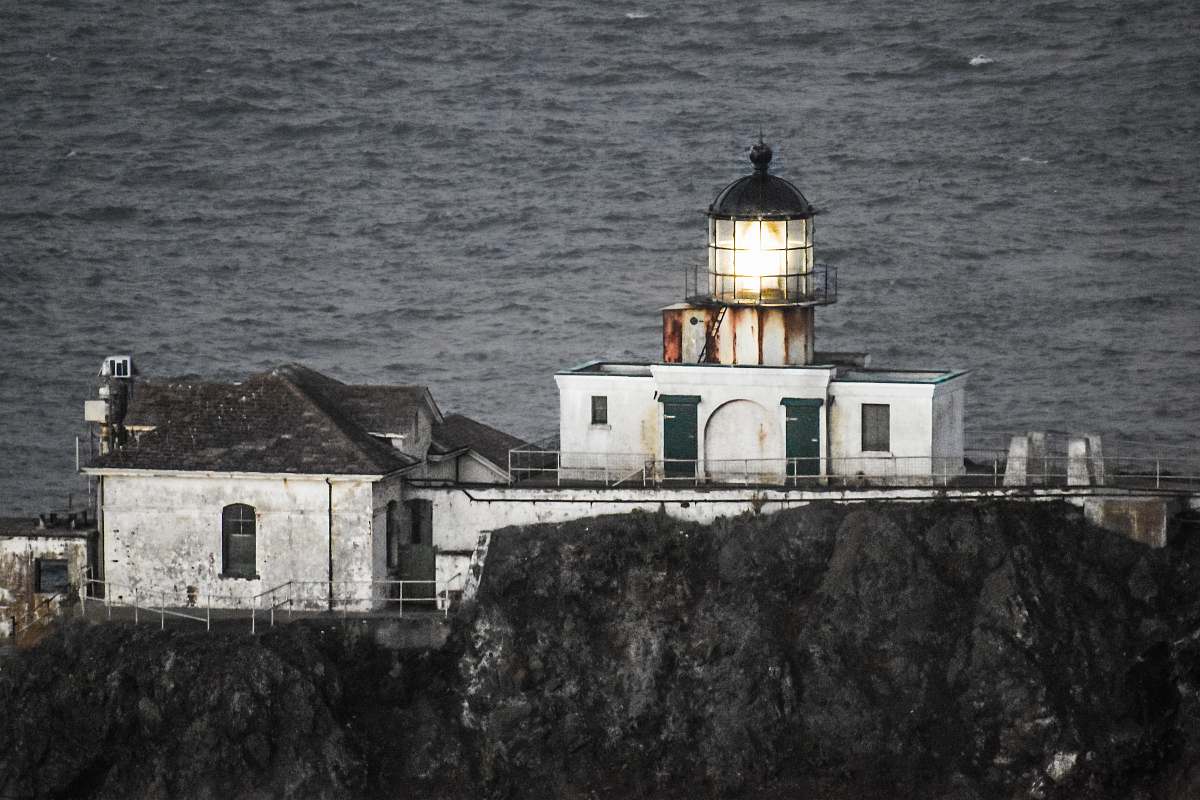 lighthouse aerial photo of white concrete lighthouse marine