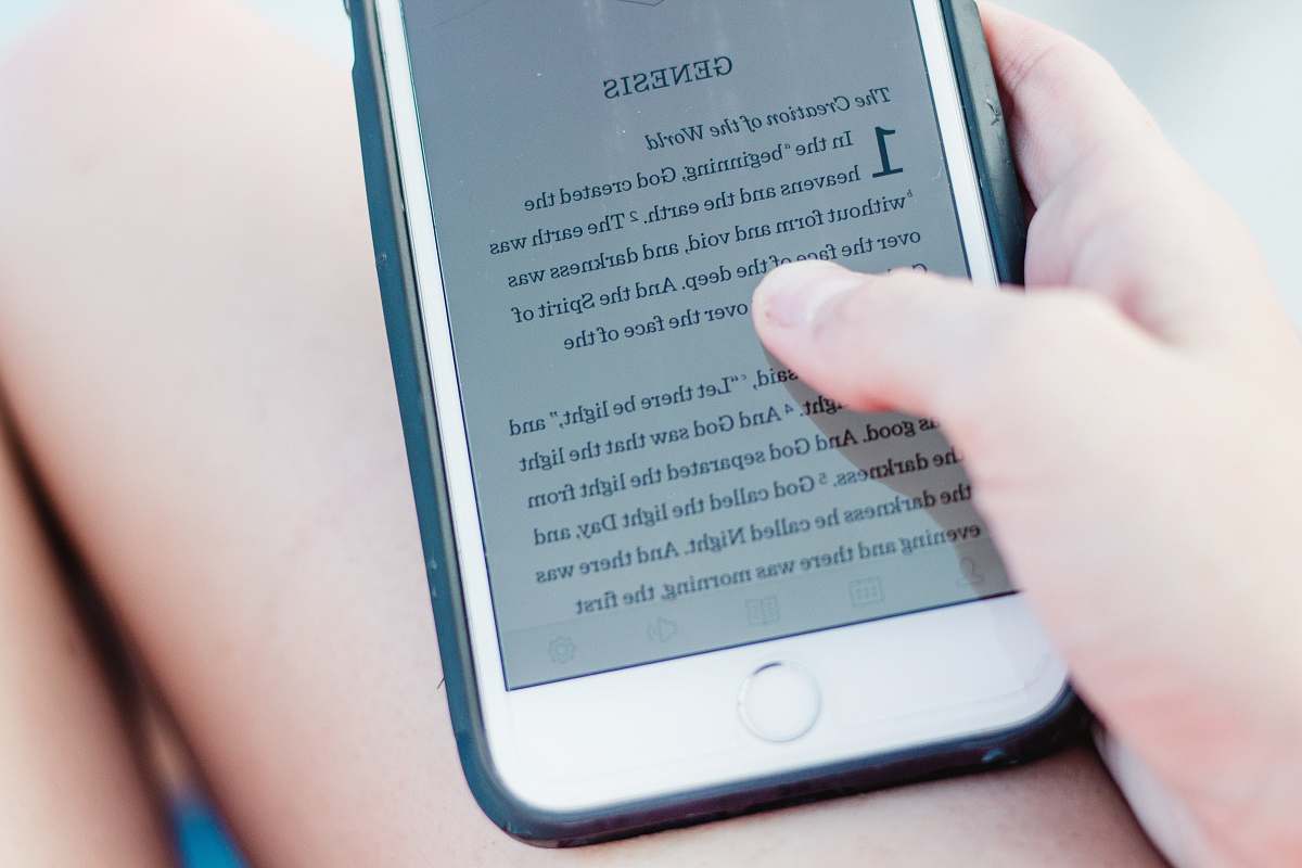 text person holding turn-on iPhone church
