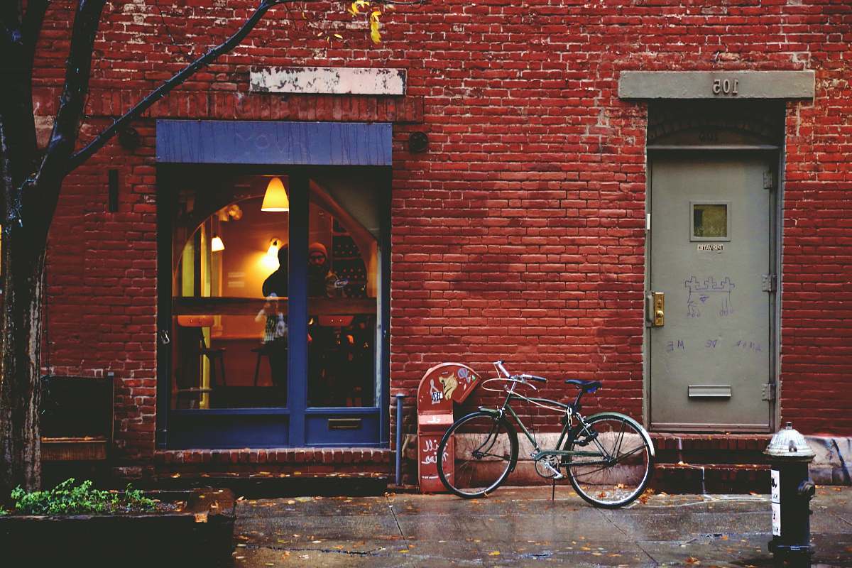 bike black bike leaning by building door transportation