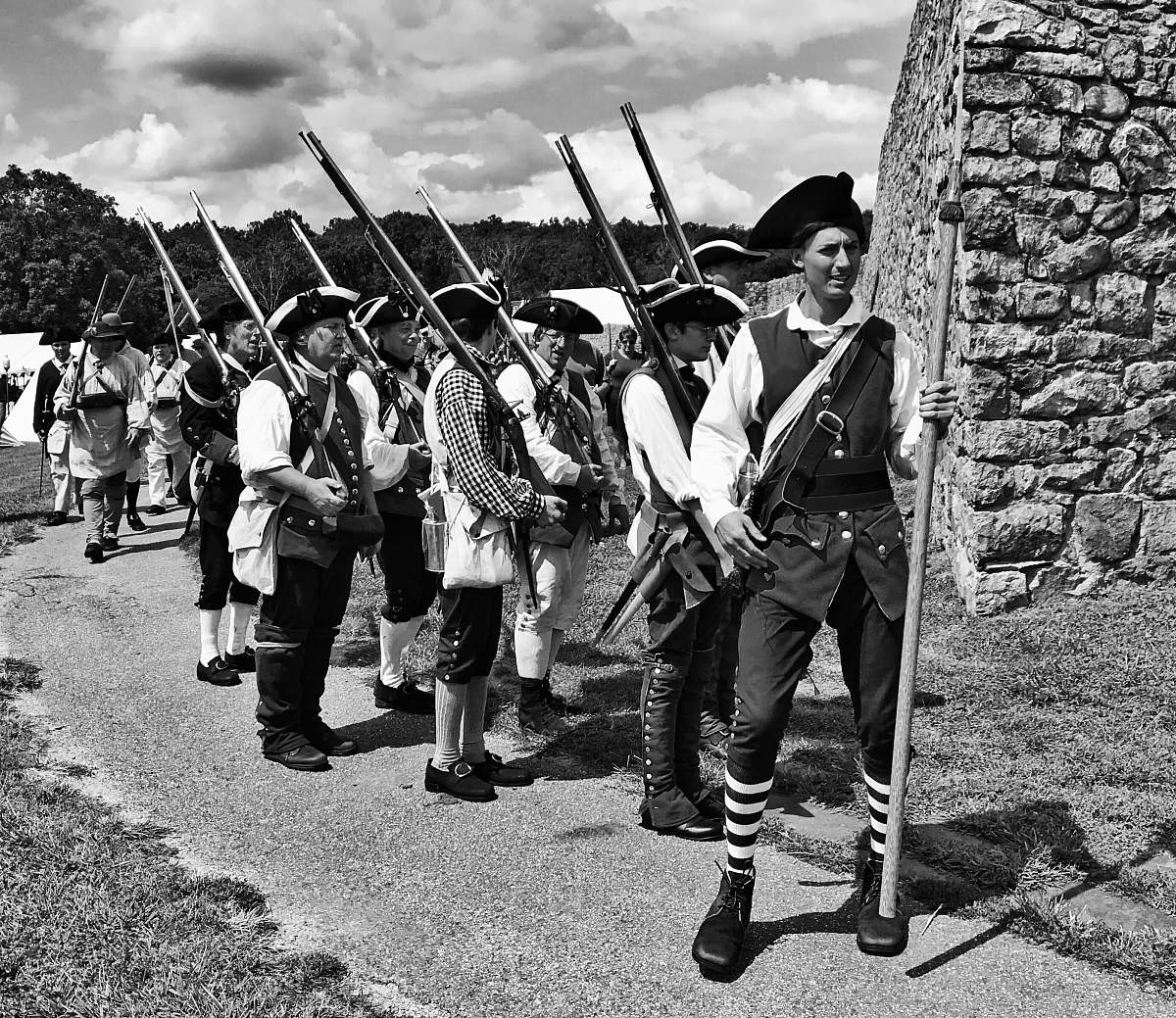 human grayscale photo of soldiers holding rifles people