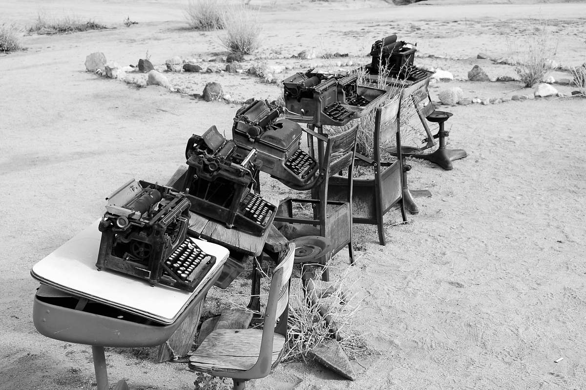 pioneertown grayscale photo of typewriter on tables desk