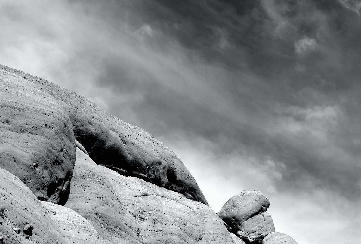 rock grayscale photography of mountain cloud