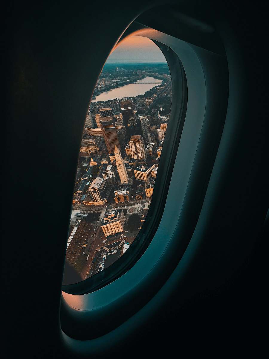 cushion view of city buildings from plane window headrest