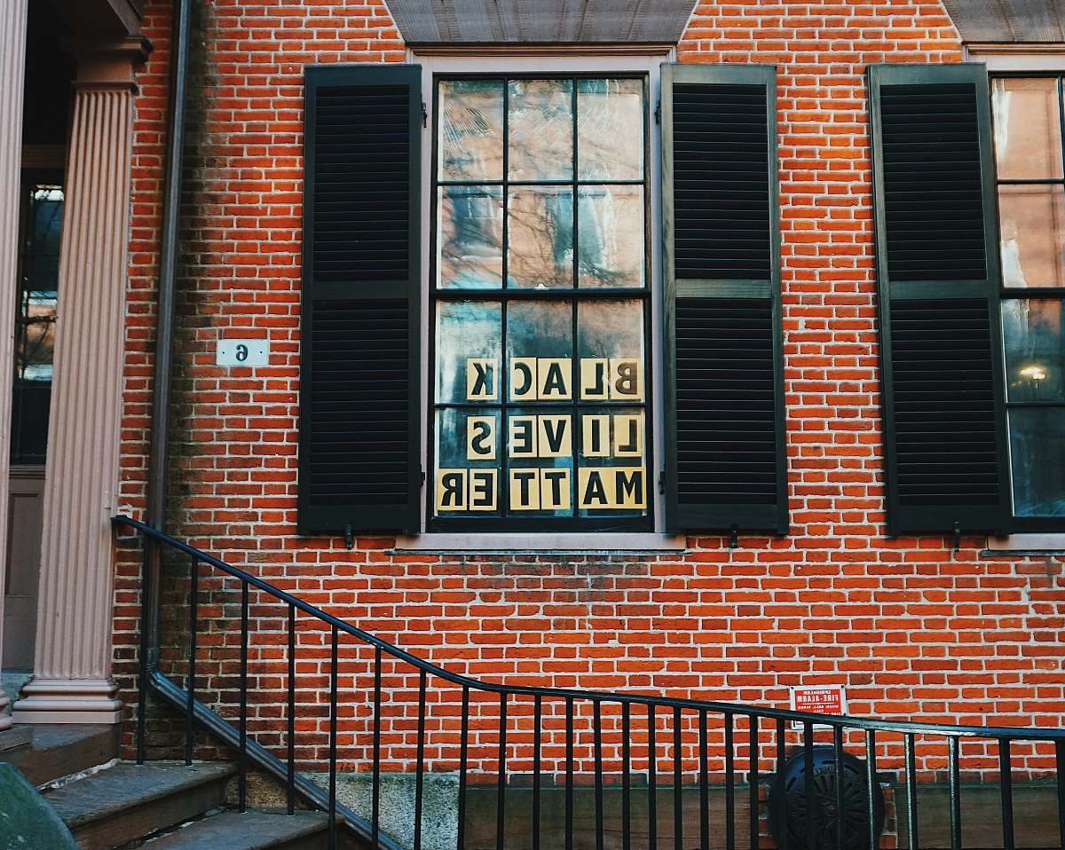 handrail black lives matters poster on window window