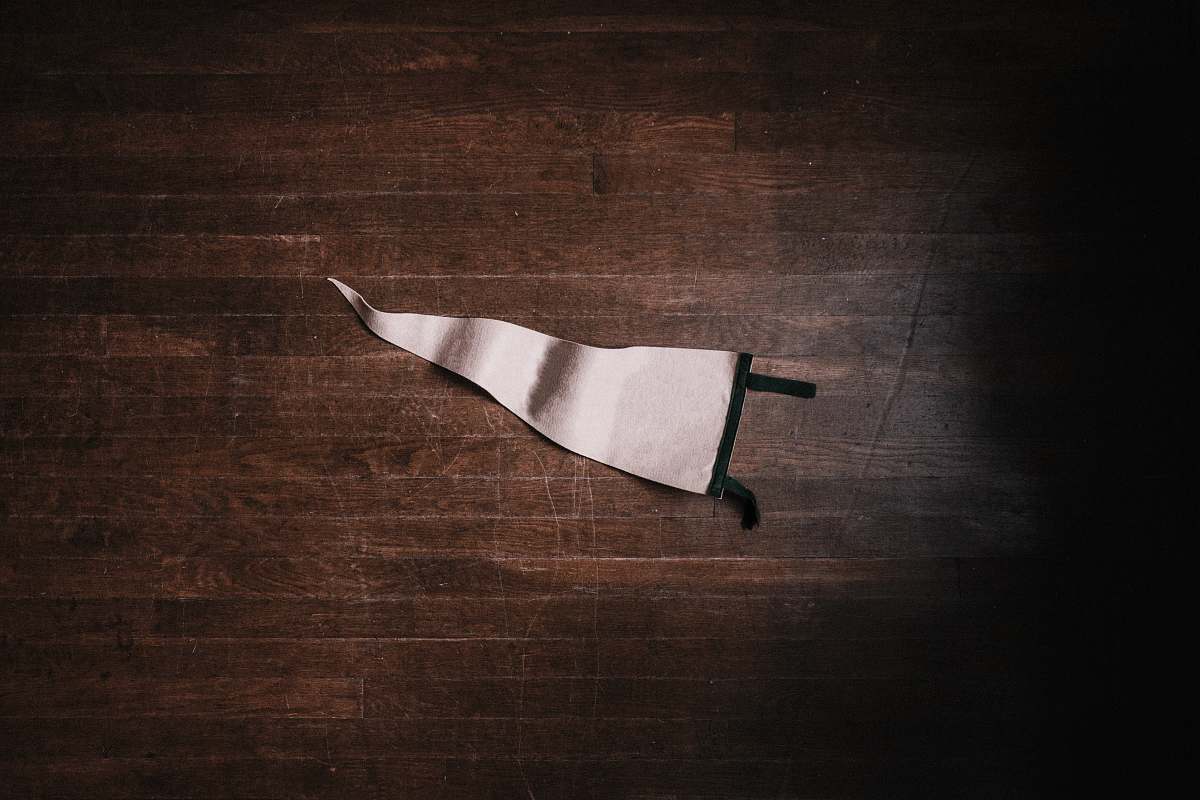 minimal white pennant on brown surface flat lay