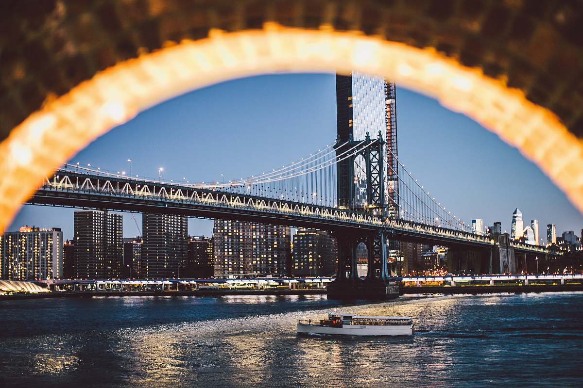 bridge boat below bridge during dusk metropolis