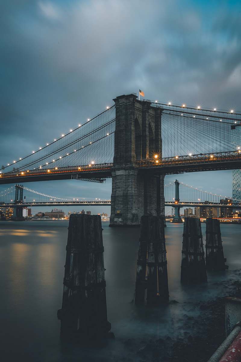 bridge Brooklyn bridge under cloudy sky water