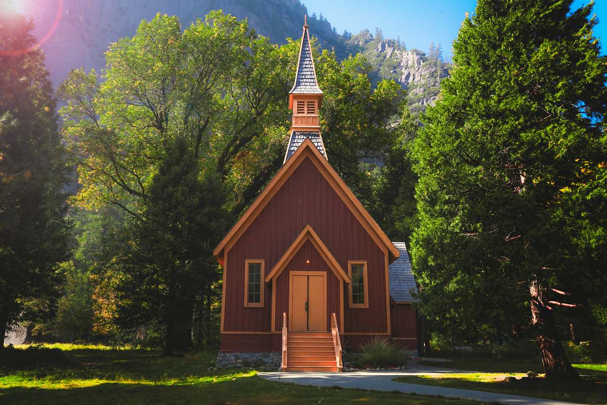 architecture brown chapel surrounded with trees spire